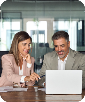 a man and woman looking at a computer in a glass conference room