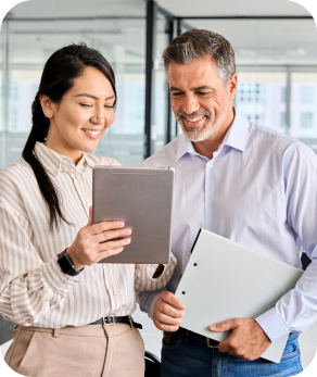 a woman and a man looking at an Ipad