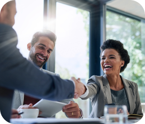 Woman shaking a man's hand in a meeting