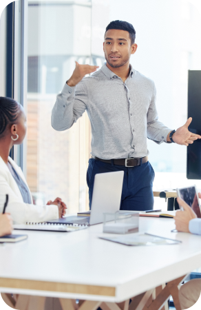 A young professional leading a meeting in a high rise conference room